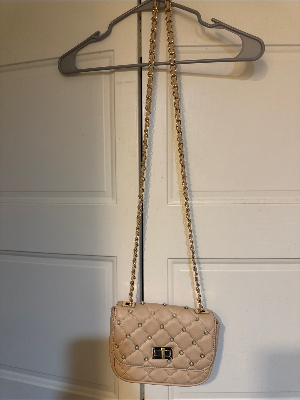 Aldo’s Cream Quilted Studded Crossbody Bag in Blush Pink